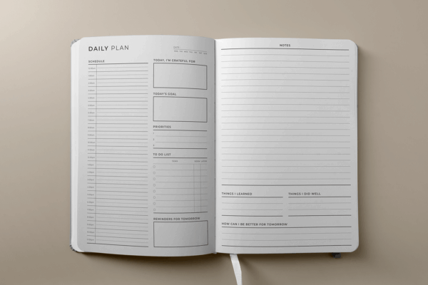 Daily planner interior showing undated layout with goal and habit trackers.